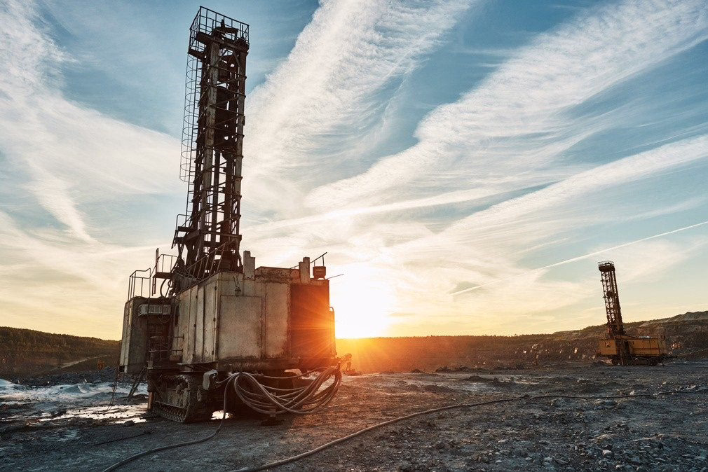 Borefield drilling rig at sunset
